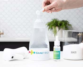 Mixing ingredients into SaniTru bottle